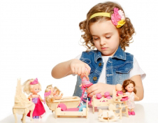 Little girl playing with dolls
